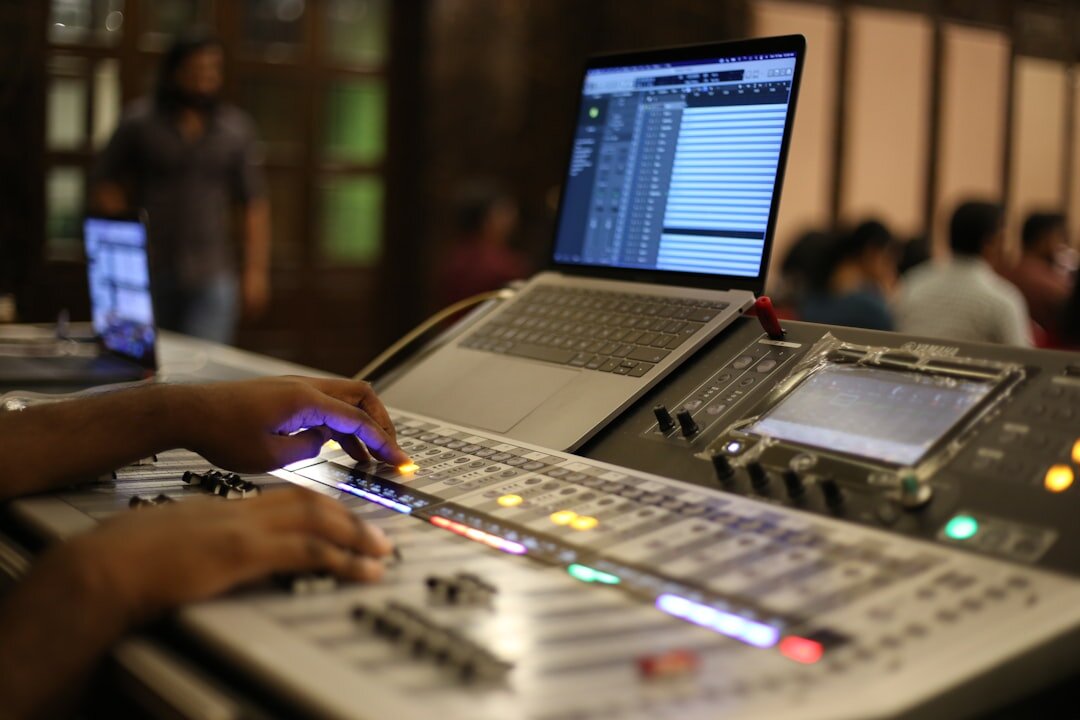 Hands operating a video vision mixer switcher panel
