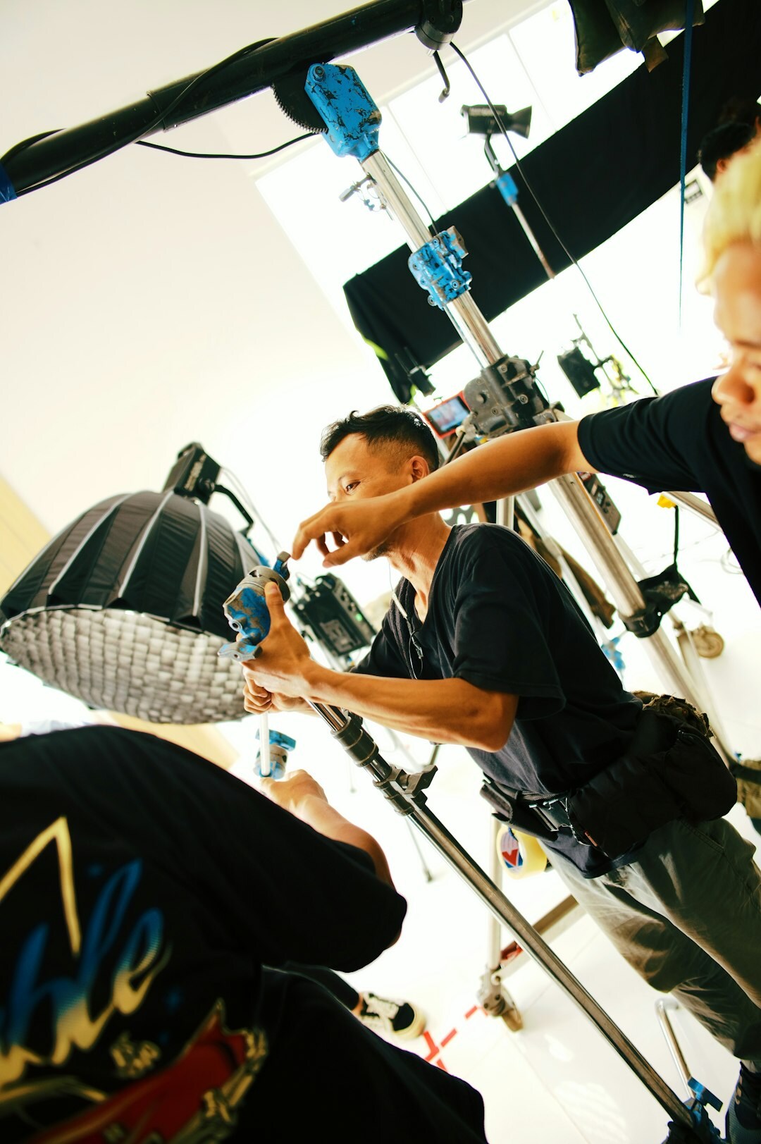 Technical crew setting up cameras and cables for a live event
