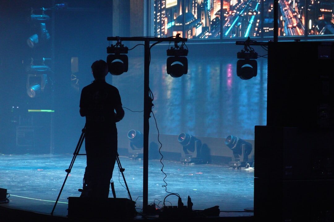Camera operator filming a live broadcast event on stage